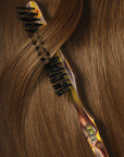 Oribe Italian Resin Teasing Brush - Product displayed on top of hair 