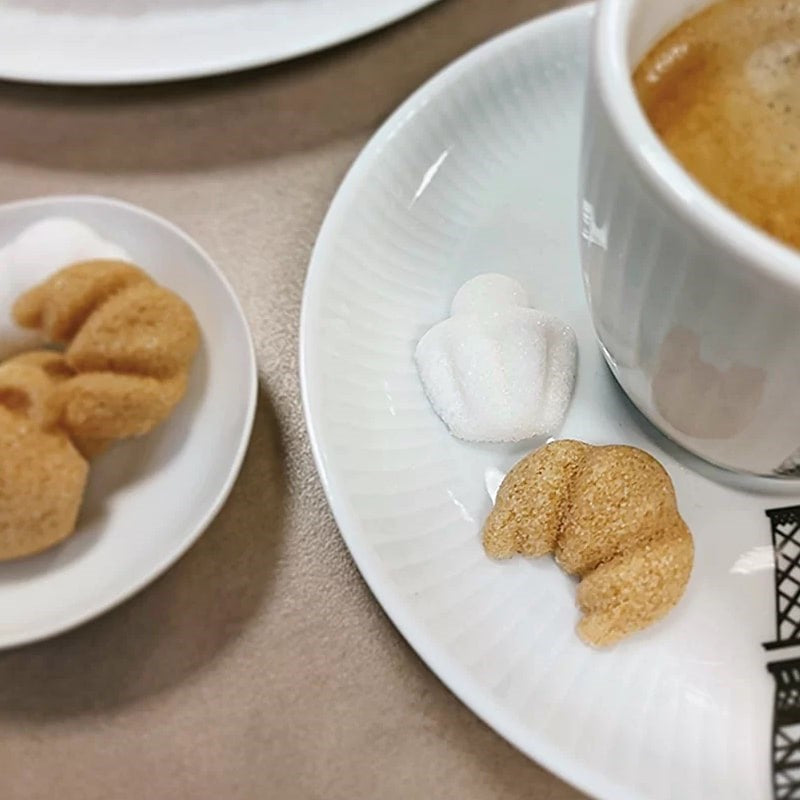 Canasuc Morning in Paris Sugars - Product displayed on plate next to coffee