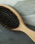 Neil Naturopathic Boar Bristle Brush - Product displayed on marble