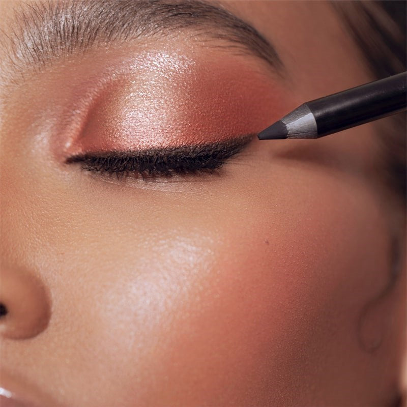 Roen Beauty Eyeline Define Eyeliner Pencil – Matte Black - Model shown applying product to eye