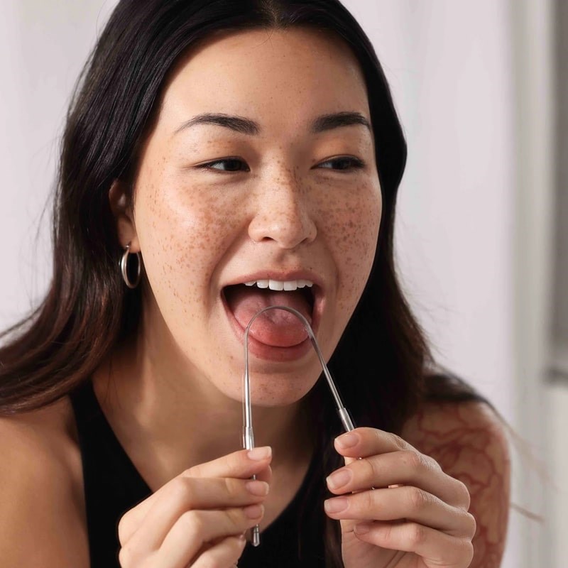 Wonder Oral Wellness Tongue Cleaner - Model photo using the tongue cleaner