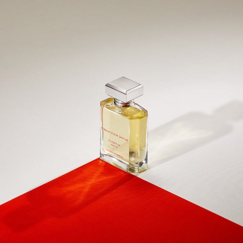 Ormonde Jayne Evernia Eau de Parfum - bottle on red fabric