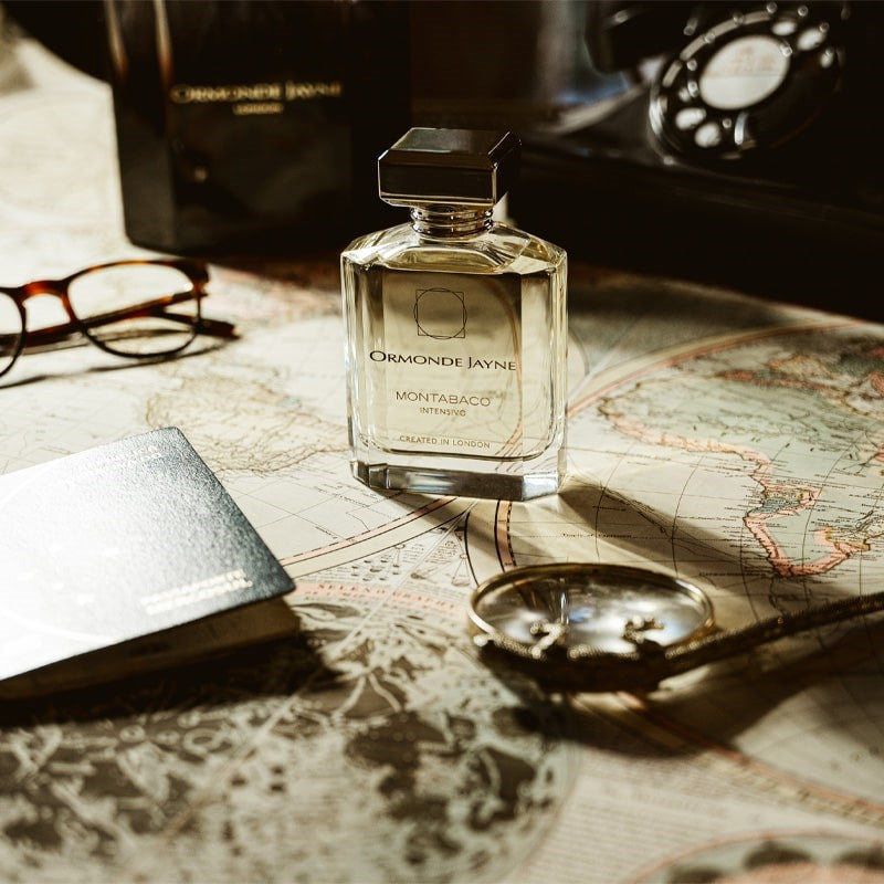 Ormonde Jayne Montabaco Intensivo Eau de Parfum - lifestyle shot of perfume bottle, glasses, phone on a map
