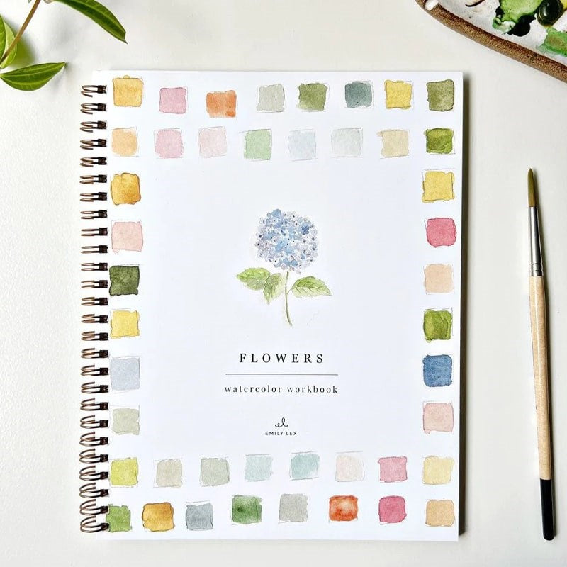 Emily Lex Studio Flowers Watercolor Workbook - workbook, paintbrush, and plant on table