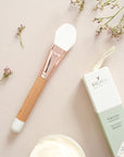 Bachca Paris Mask Applicator Brush - brush next to packaging and flowers on table