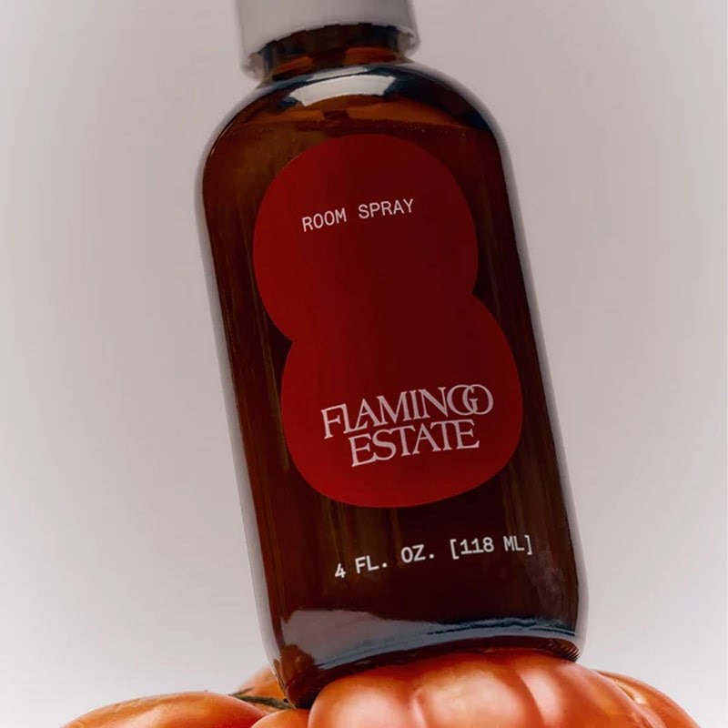 Flamingo Estate Organics Roma Heirloom Tomato Room Spray - close up of bottle on top of tomato