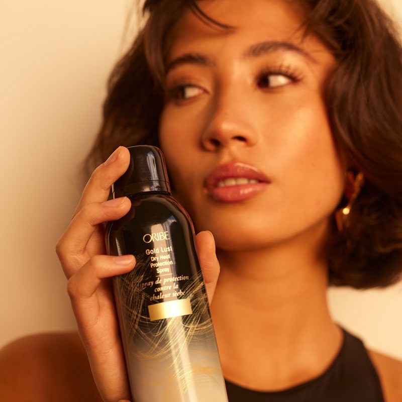 Oribe Gold Lust Dry Heat Protection Spray- Model shown with product in hand