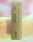 Pink House Organics Lip Balm - Green Tea - Product shown on colorful background