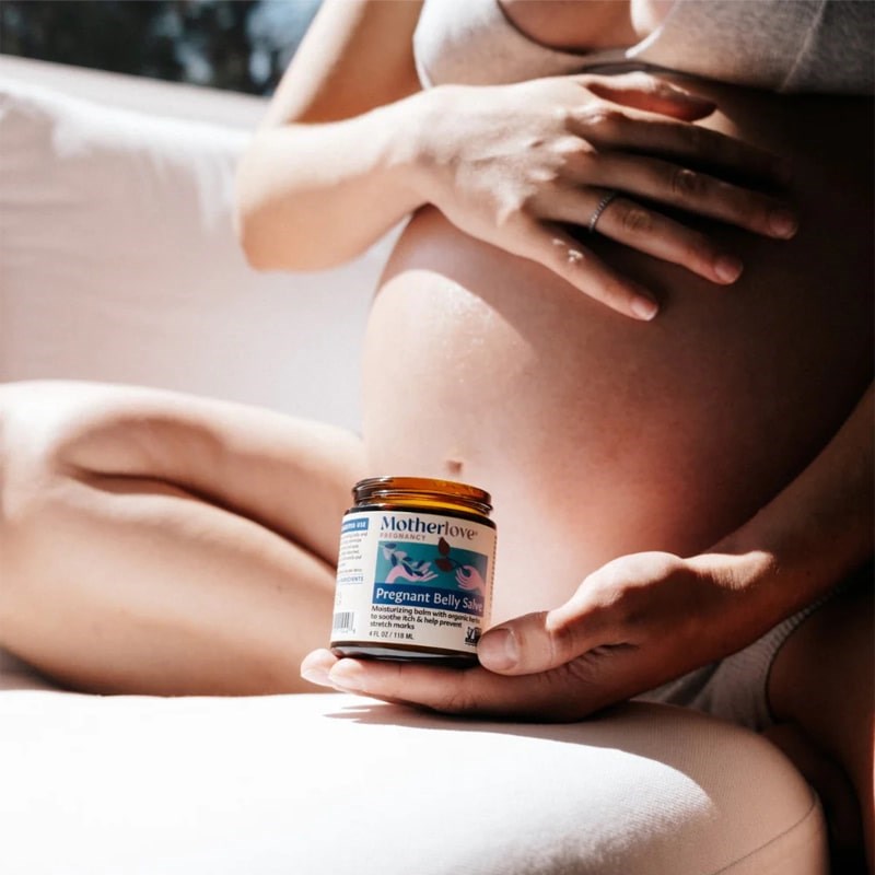Motherlove Pregnant Belly Salve - Model shown holding product in front of belly