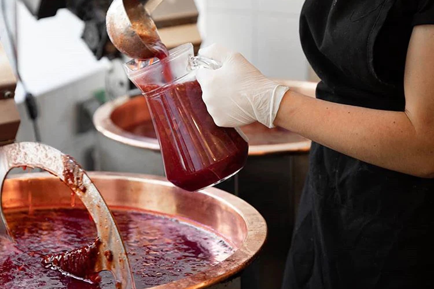 Lifestyle shot of Confiture Parisienne Jam being made in a copper cauldron 