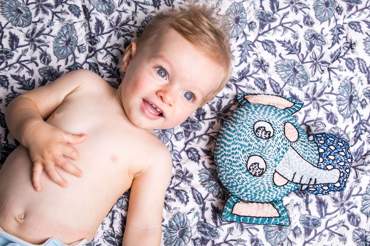 Lifestyle shot, top view of Baby with Malabar Baby Handmade Kantha Elephant Lovey Rattle