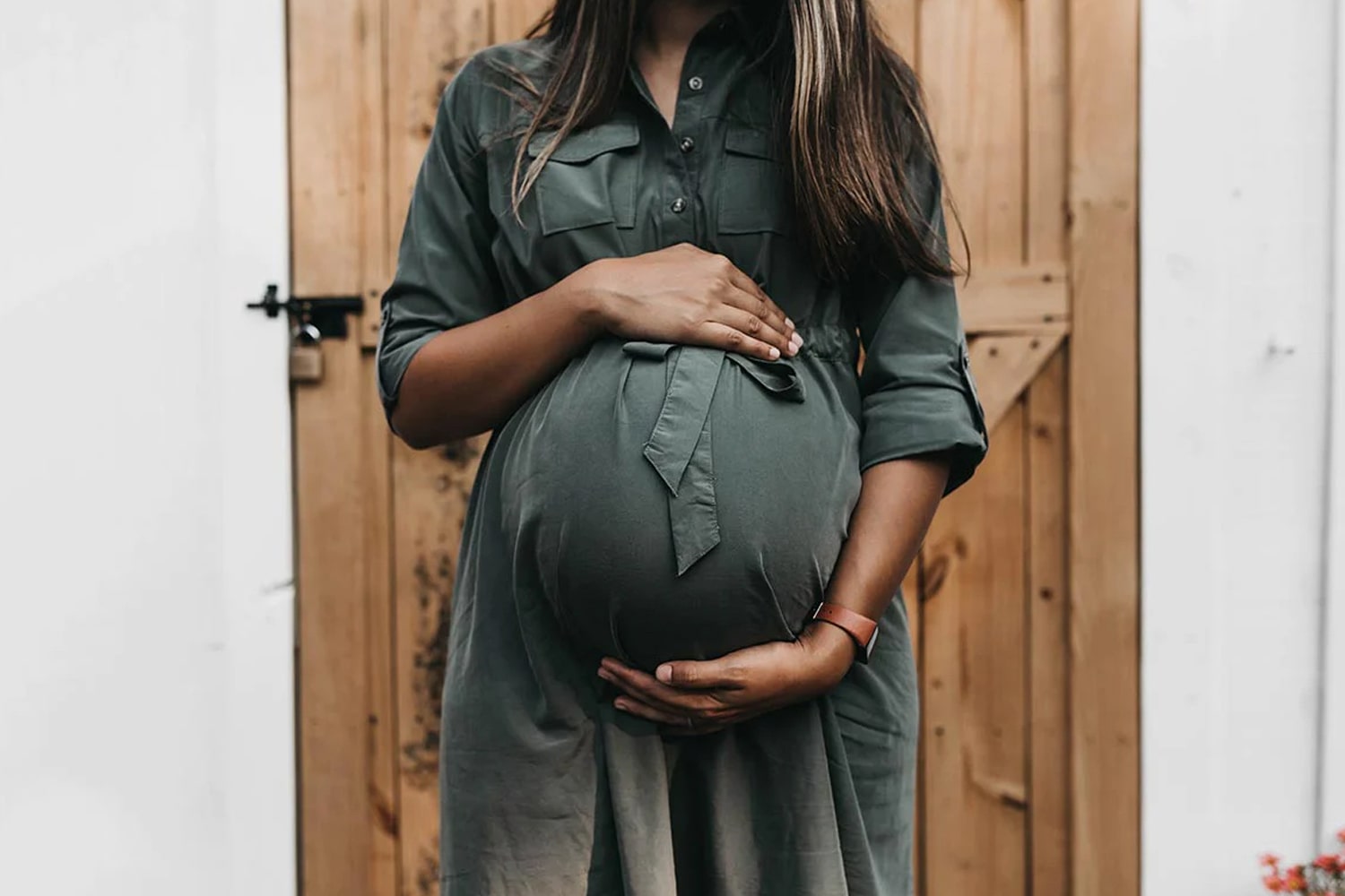 Shot of pregnant model cradling her belly