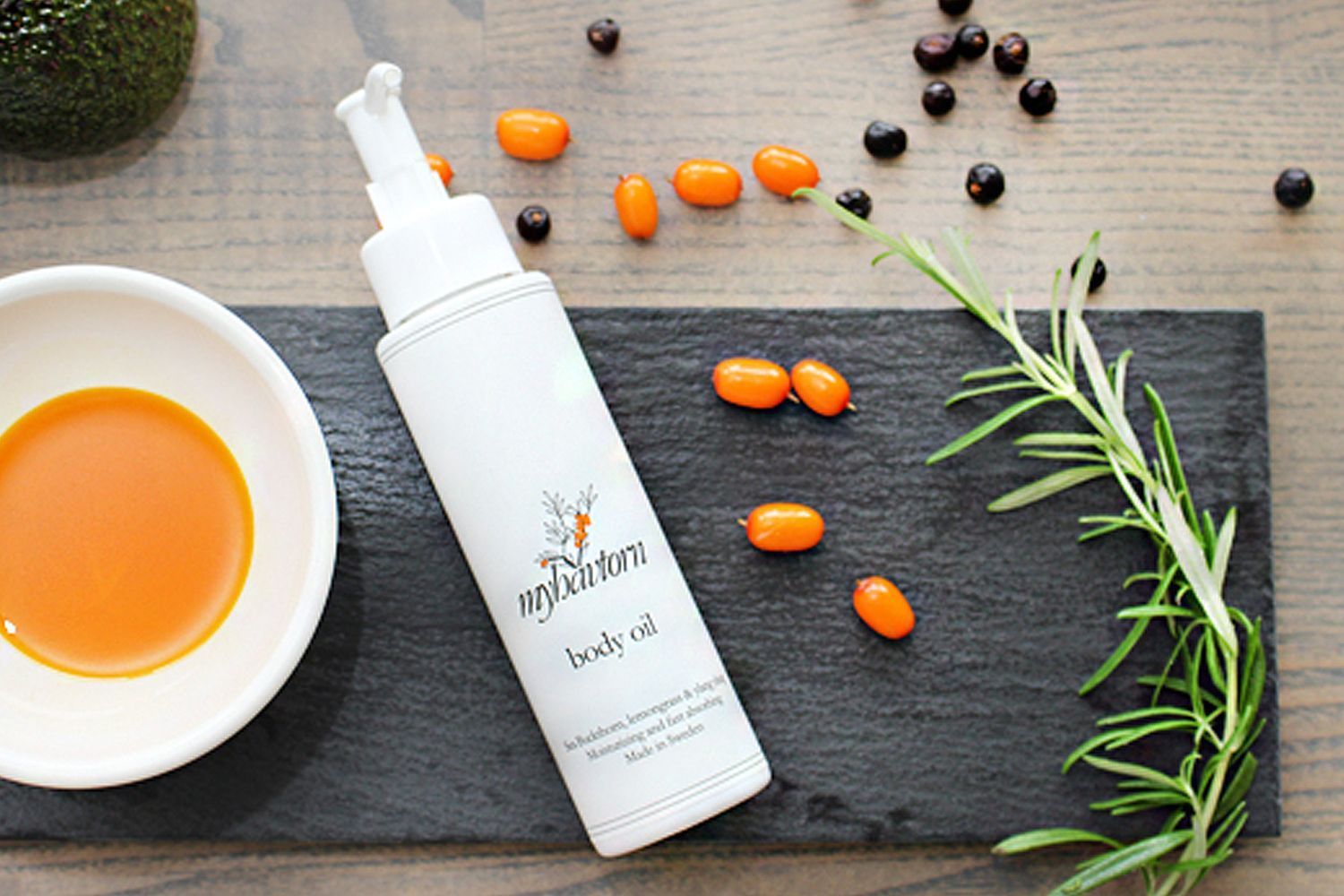 Beauty shot top view of MyHavtorn Body Oil in bottle and oil in dish