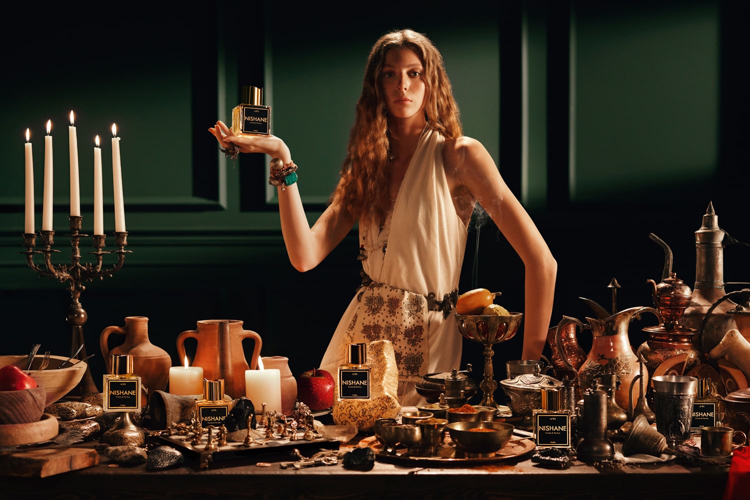 Lifestyle shot with model holding Nishane Ani Extrait de Parfum