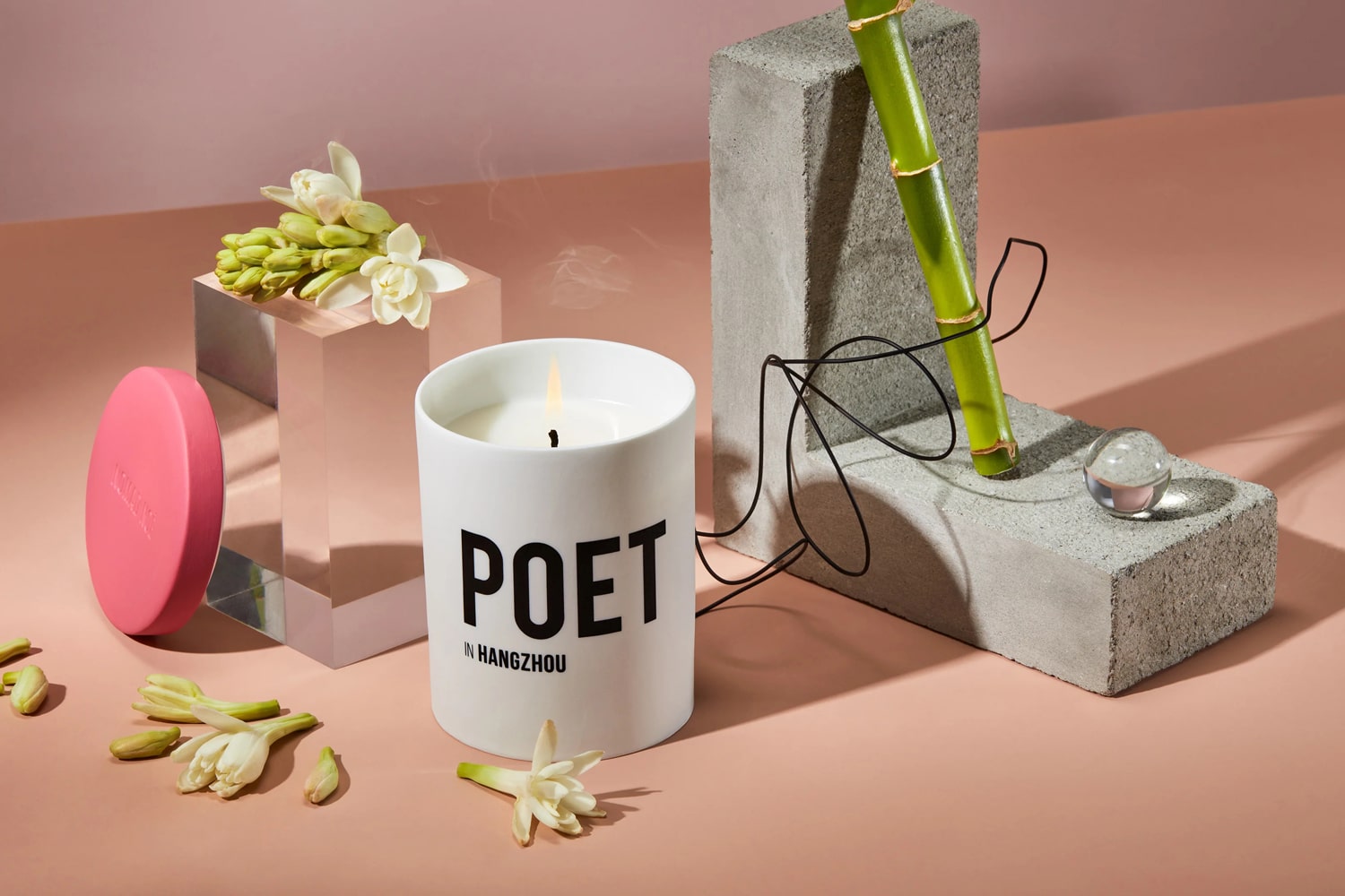 Lifestyle shot of Nomad Noe Poet in Hangzhou Bamboo & Tuberose Candle