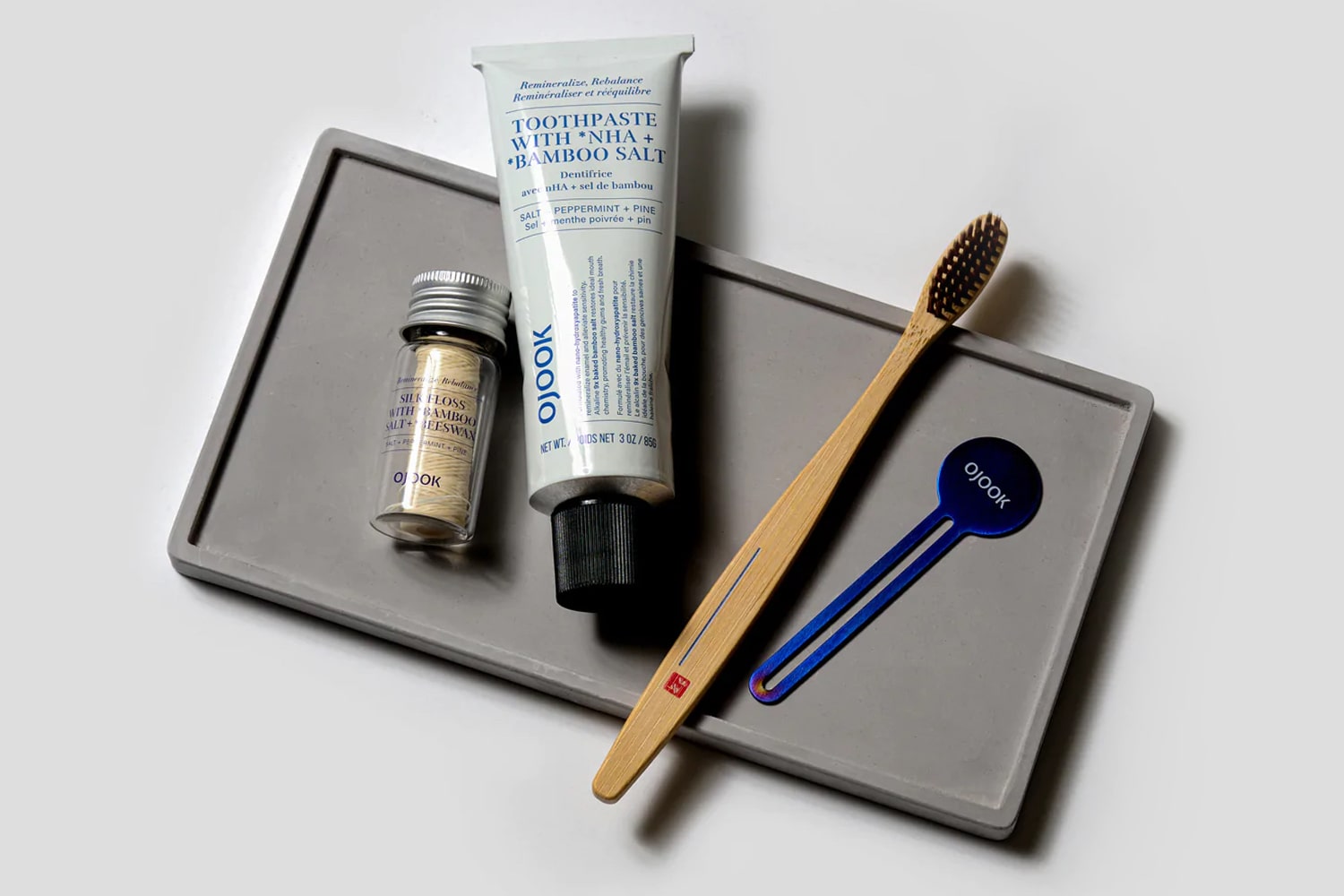 A selection of OJOOK dental products on a vanity tray