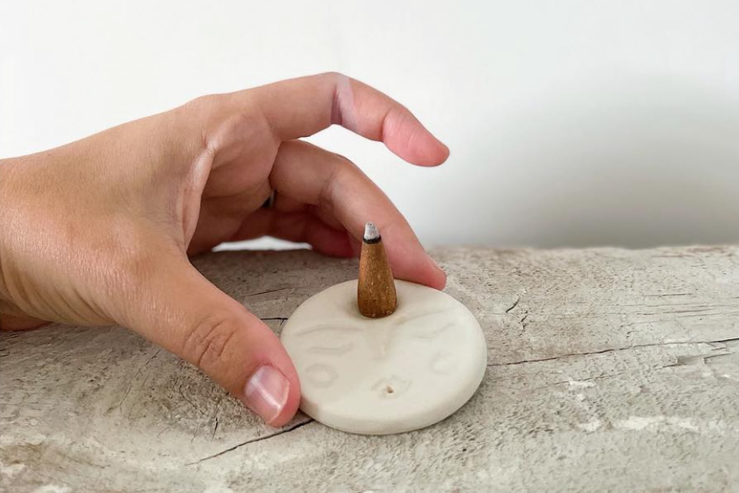 Lifestyle shot of model holding Okini Ceramics Moon Incense Holder
