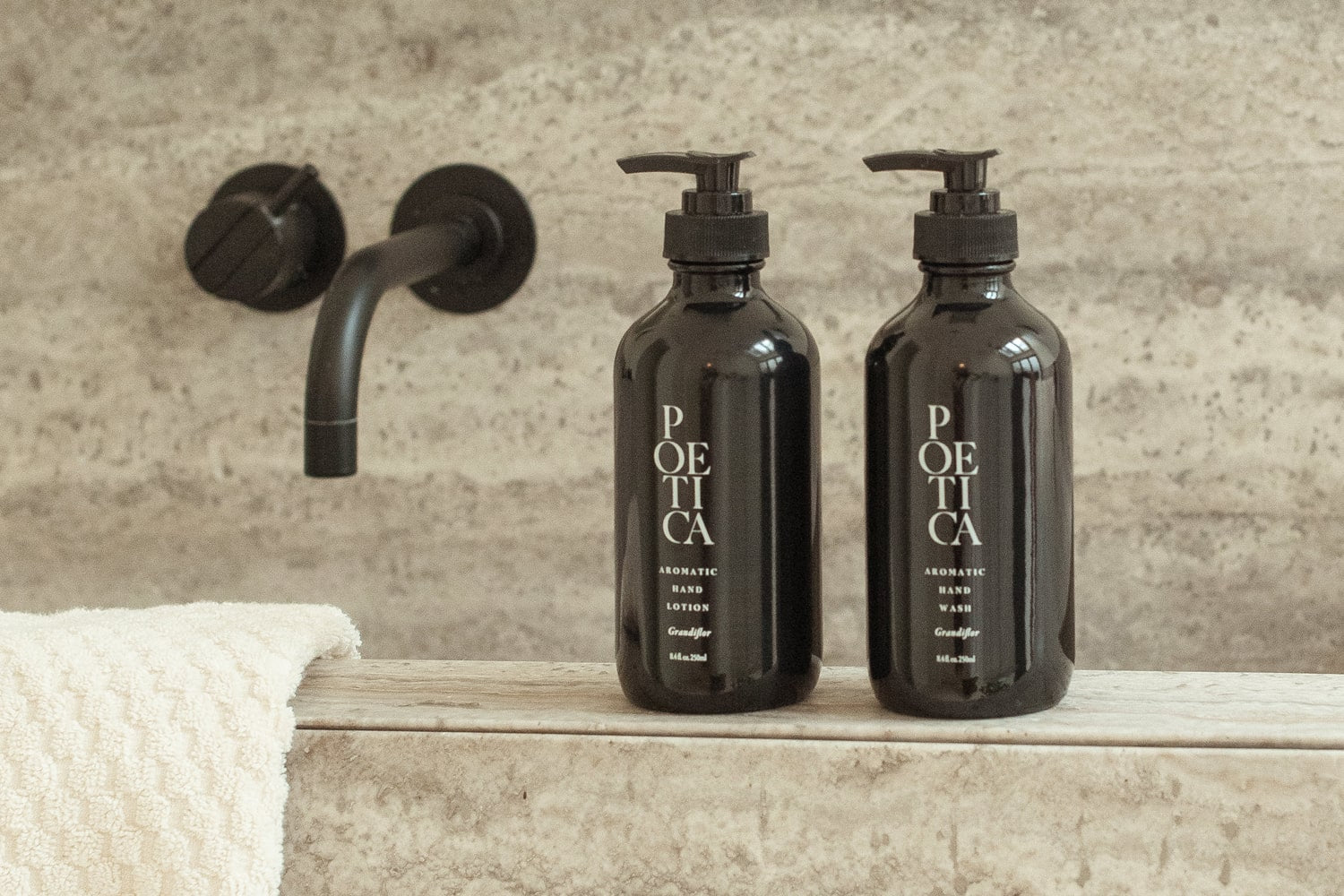 A selection of Poetica Hand Wash and Hand Lotion displayed on marble sink