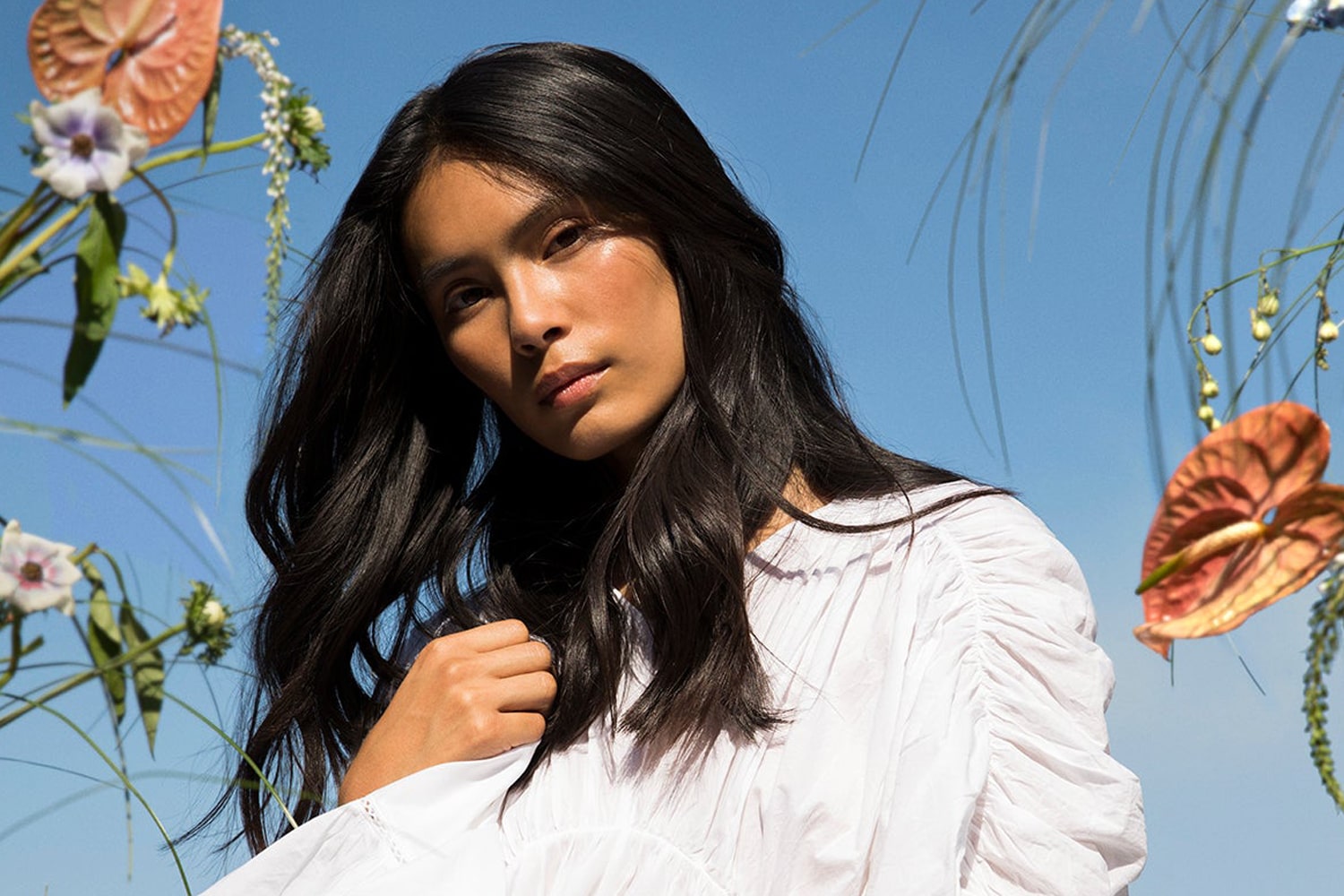 Model for Roz Hair Care with beautiful hair with flowers in the background