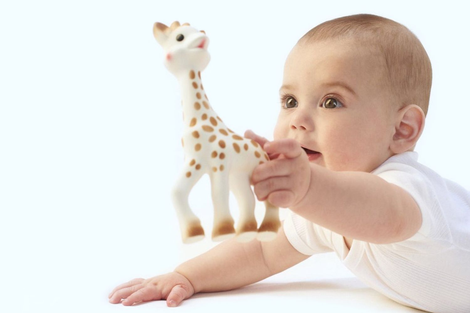 Baby holding a Fresh Touch Sophie la Giraffe