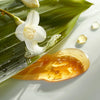 Leonor Greyl Banane Shampoo Bain Restructurant a la Banane (200 ml) - product swatch shown next to hibiscus flower and leaf. 