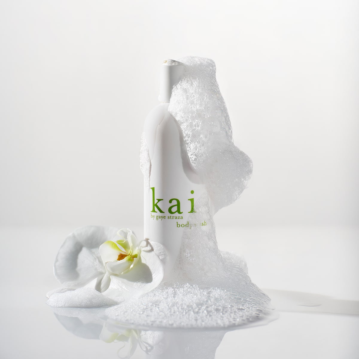 Kai Fragrance Body Wash (8 oz) - product shown lathered and with a white flower