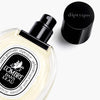 Diptyque L'Ombre Dans L'eau Eau de Toilette (50 ml) - product shown on its back with lid off. 