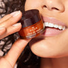 Nuxe Reve de Miel Lip Balm - model holding product close to face