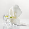 Kai Fragrance Body Buffer (2 x 2.75 oz.) shown with lather and next to a white flower