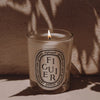 Diptyque Figuier (Fig) Candle - life style of lit candle outside
