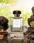 Lifestyle shot of Carthusia Uomo Eau de Parfum (100 ml) with rocks and forest in the background