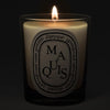 Diptyque Maquis Candle - lit candle shown