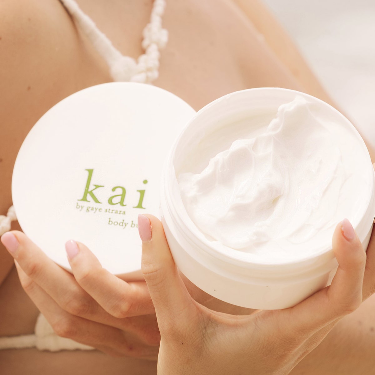 Kai Fragrance Body Butter (6.4 oz) held by a person.