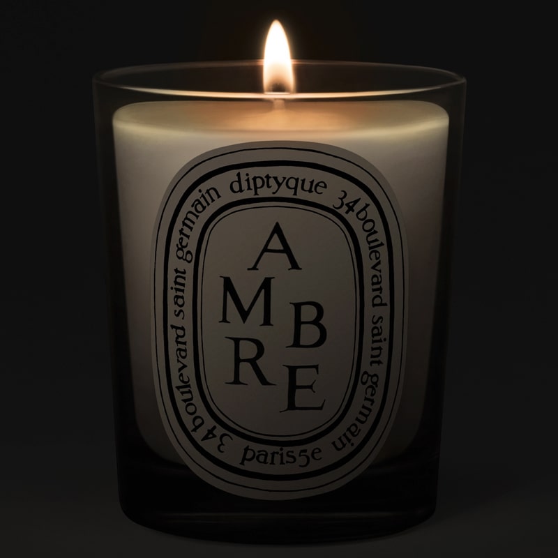 Diptyque Ambre (Amber) Candle - lit candle shown