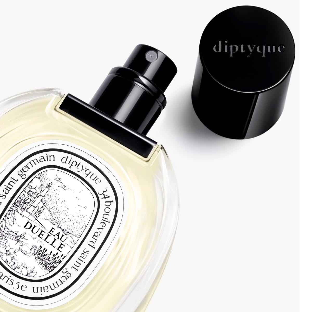Diptyque Eau Duelle Eau de Toilette (50 ml) - product shown laying on back with lid off. 