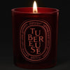 Diptyque Tubereuse Rouge Candle (300 g) - product shown on a dark background while lit. 