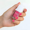 Close up of model wearing Kure Bazaar Nail Lacquer - Fabulous (10 ml) and holding bottle