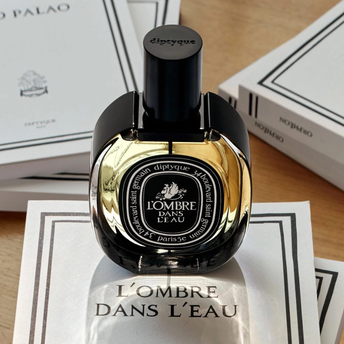 Diptyque L'Ombre Dans L'Eau Eau de Parfum (75 ml) - product shown on top of paper. 