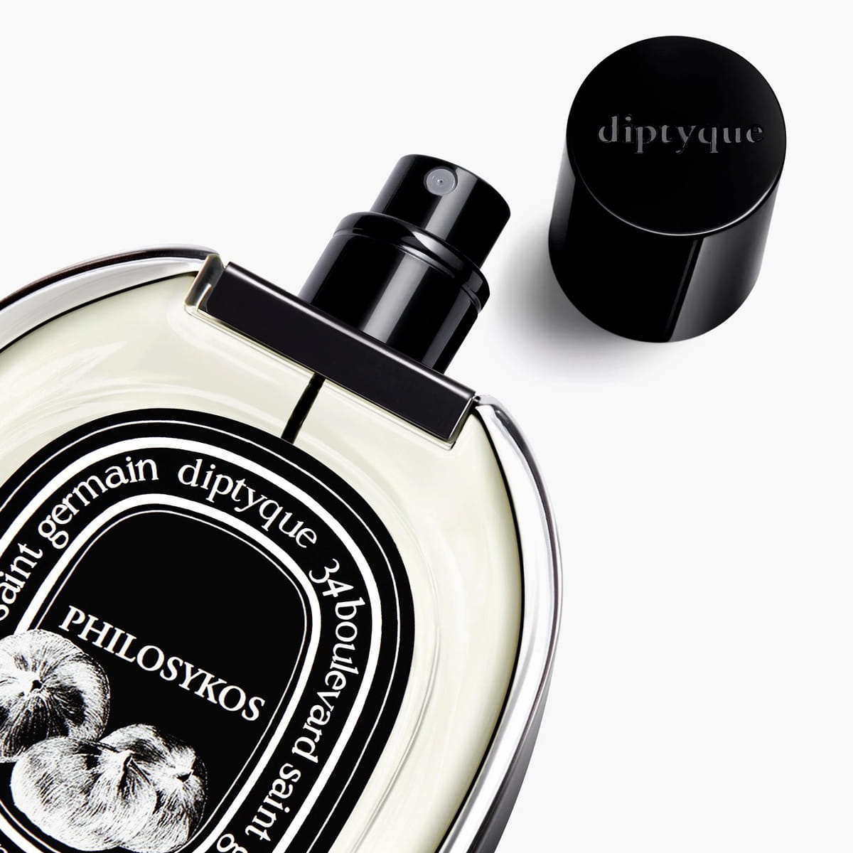 Diptyque Philosykos Eau de Parfum Spray 75 ml - product shown laying on its side with lid off. 