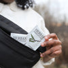 Model taking single Herban Essentials Eucalyptus Towelette packette from fanny pack