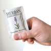 Herban Essentials Lavender Towelettes (20 pcs) - model shown holding individually wrapped product