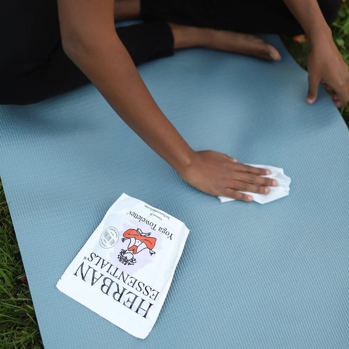 Model using Herban Essentials Yoga Towelette on yoga mat