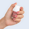 Close up of model wearing Kure Bazaar Nail Lacquer - So Vintage (10 ml) and holding bottle