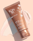 Top view shot of Yon-Ka Paris SPF 50 Creme with product smear in the background to show color and texture