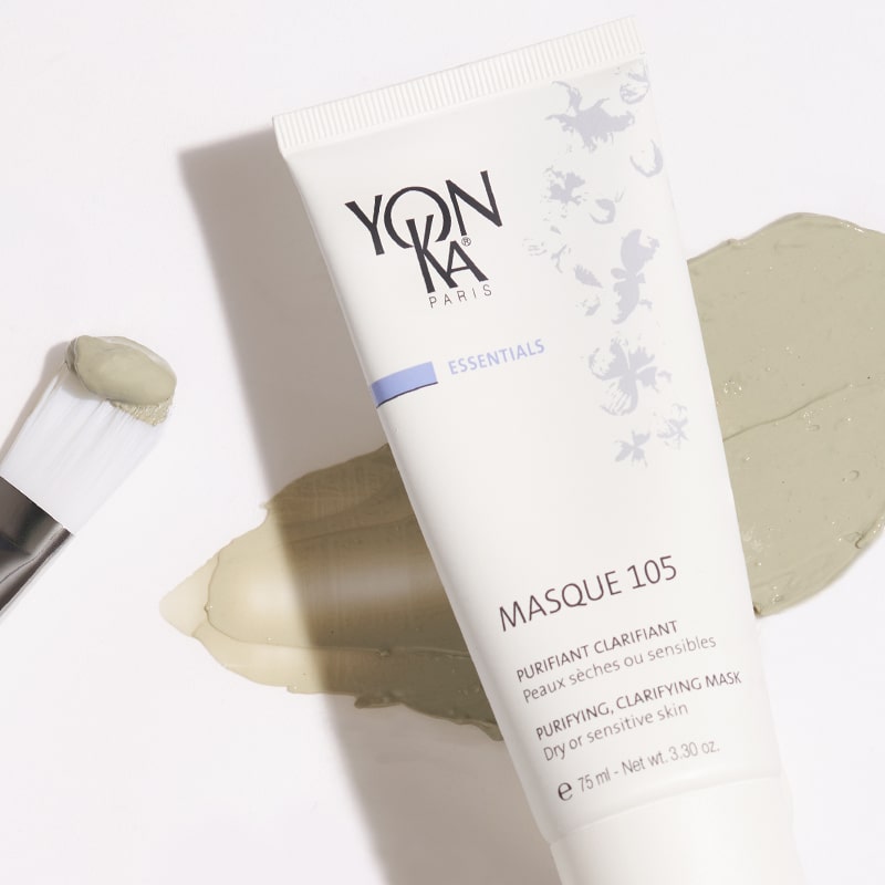 Close up shot of Yon-Ka Paris Masque 105 (75 ml) with product smear in the background to show green color and texture