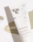 Close up shot of Yon-Ka Paris Masque 105 (75 ml) with product smear in the background to show green color and texture