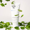 Lifestyle shot of Yon-Ka Paris Nettoyant Creme (100 ml) with mint in the background