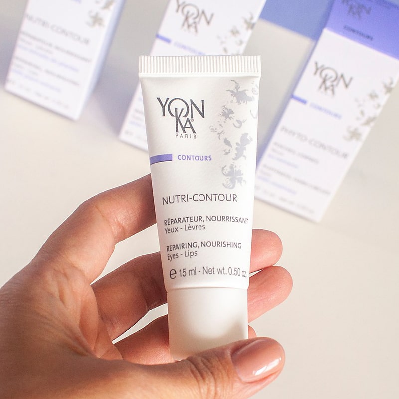 Model holding Yon-Ka Paris Nutri-Contour (15 ml) to show scale with Yon-Ka boxes in the background