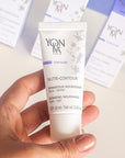 Model holding Yon-Ka Paris Nutri-Contour (15 ml) to show scale with Yon-Ka boxes in the background