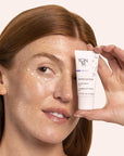 Model holding tube of Yon-Ka Paris Phyto-Contour (15 ml) and cream shown applied to under eye area